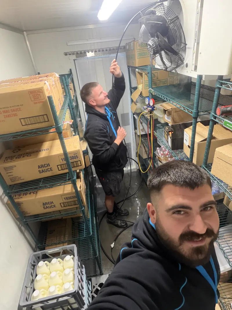 Calabreeze technicians inside a stocked commercial cool room