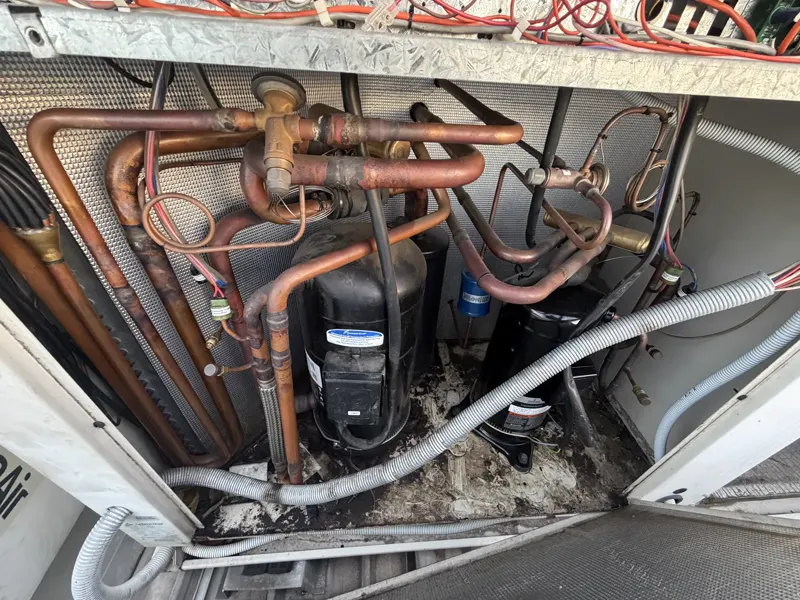 Compressors and copper pipework inside a commercial HVAC unit