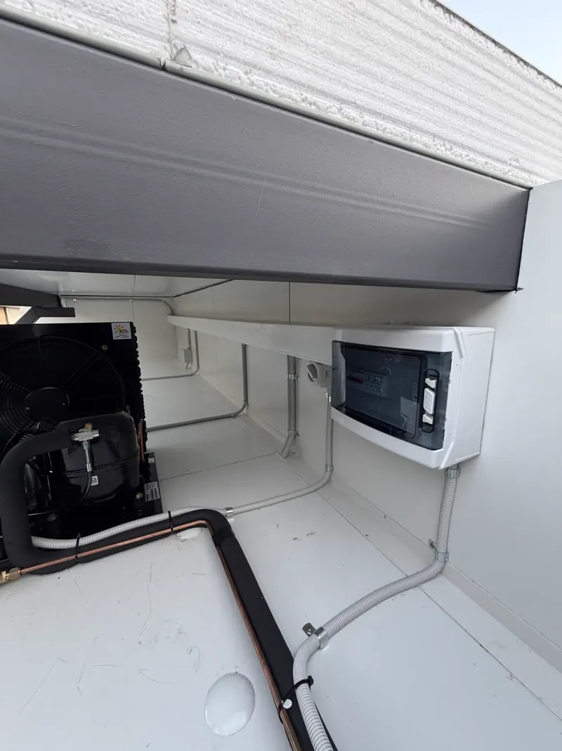 Cool room condensing unit and control box installed in a plant bay