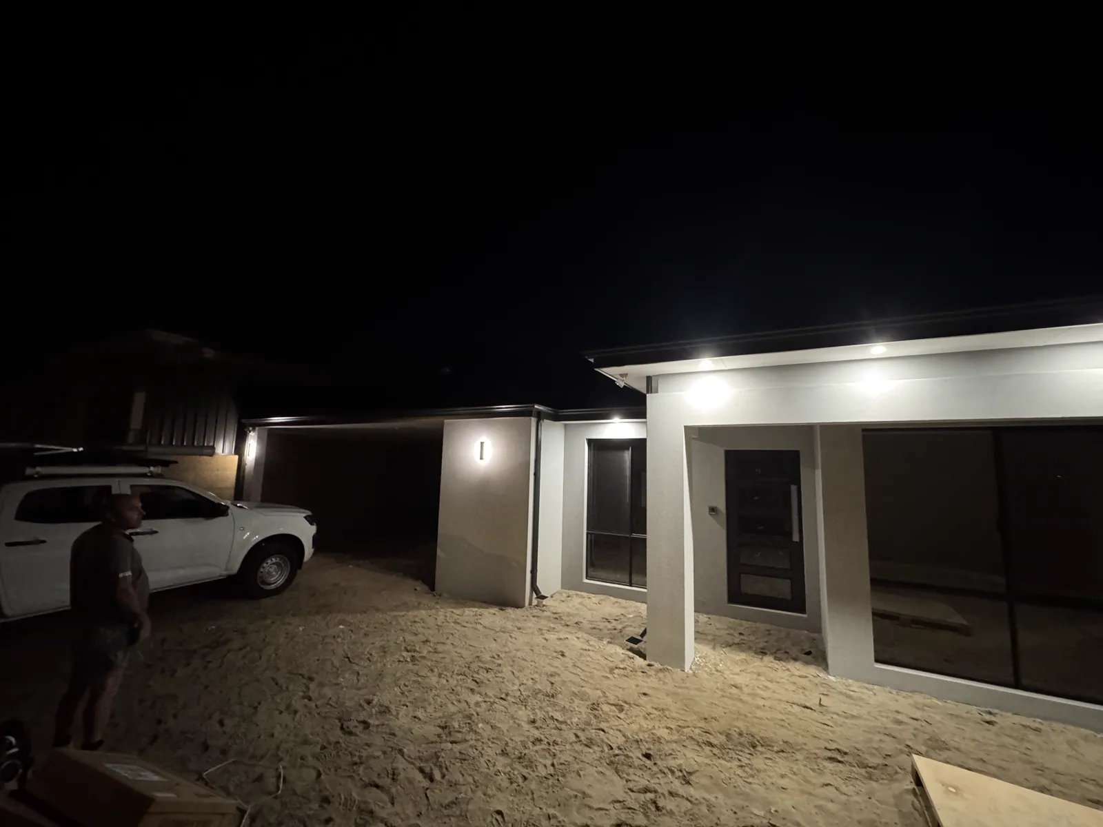 Perth home exterior lit at night — lighting and security wiring by Calabreeze