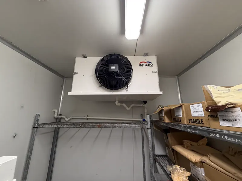 Stocked commercial cool room with Cabero evaporator running